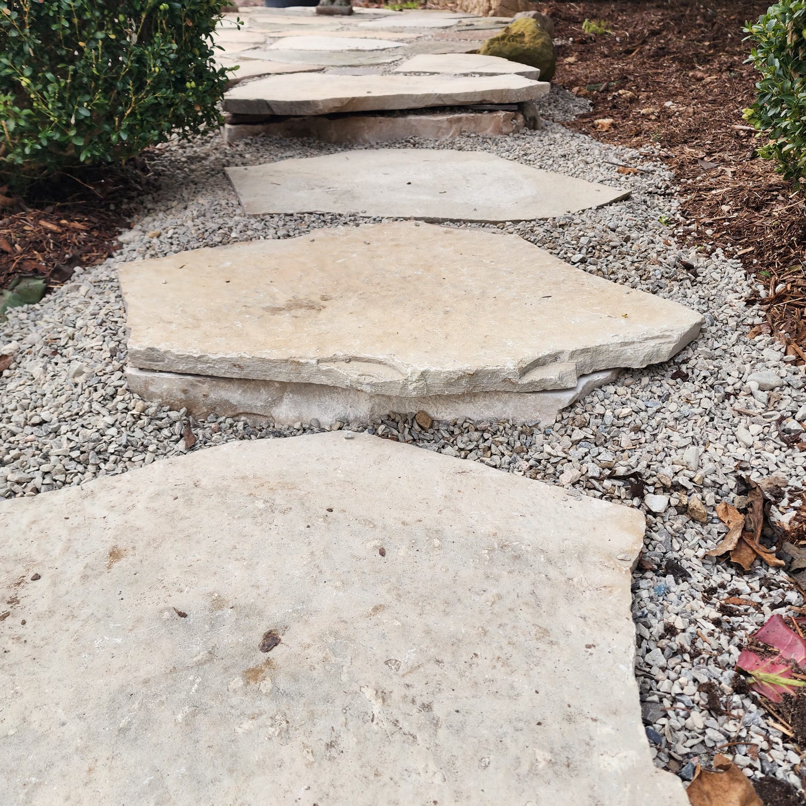 Small steps going into the new patio with natural stone risers
